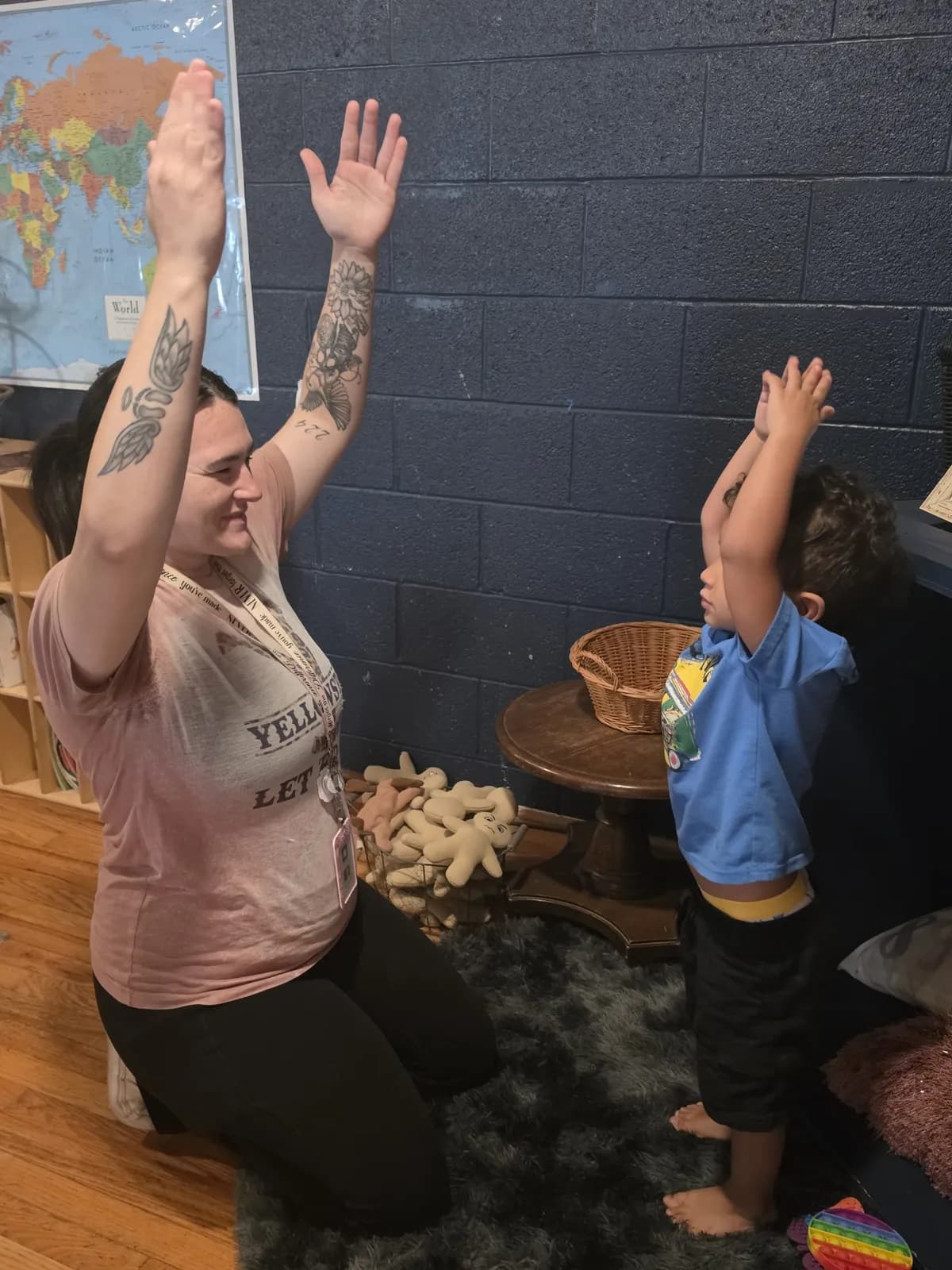 Teacher and child stretching together